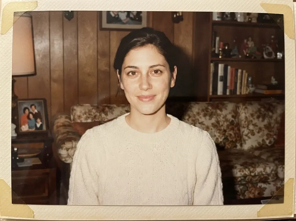 AI family-album result with a cream knit sweater, warm living room and generated paper photo border